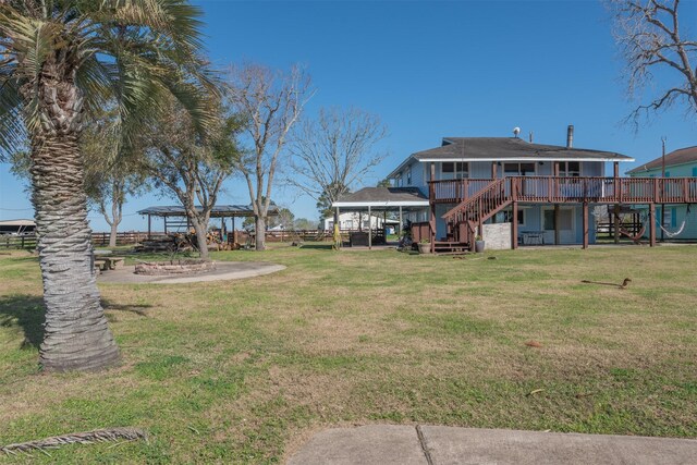 view of yard with a wooden deck and stairs