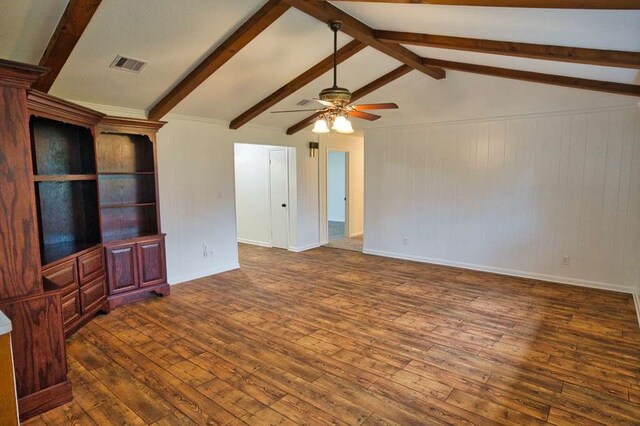 unfurnished living room with baseboards, visible vents, vaulted ceiling with beams, ceiling fan, and hardwood / wood-style flooring