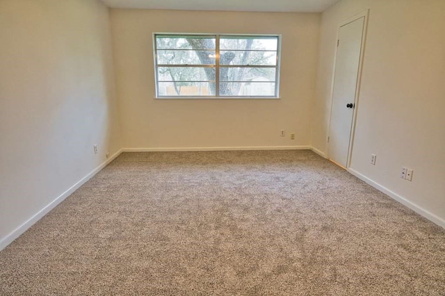 empty room with baseboards and carpet floors