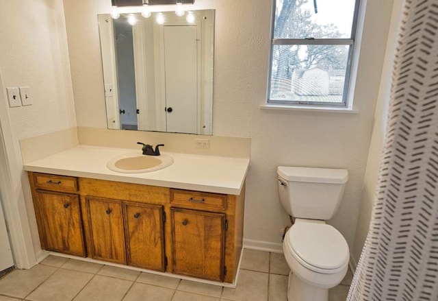 full bathroom featuring baseboards, toilet, vanity, and tile patterned flooring