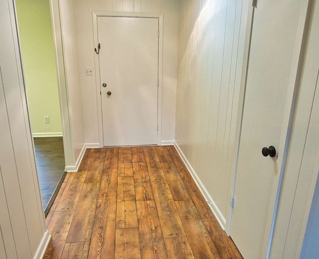 doorway to outside with baseboards and hardwood / wood-style floors