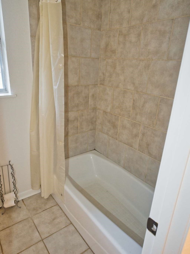 bathroom featuring tile patterned floors and shower / tub combo with curtain