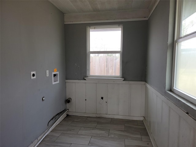 clothes washing area with laundry area, hookup for a washing machine, a wainscoted wall, and hookup for an electric dryer