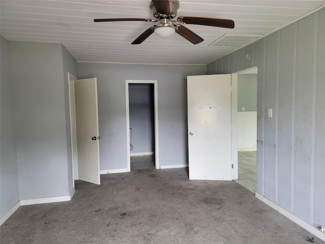 unfurnished bedroom featuring a ceiling fan, carpet, and visible vents