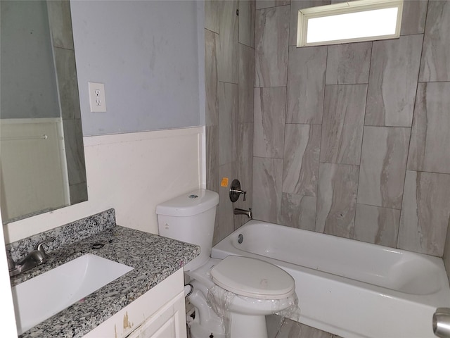 bathroom with washtub / shower combination, toilet, and vanity