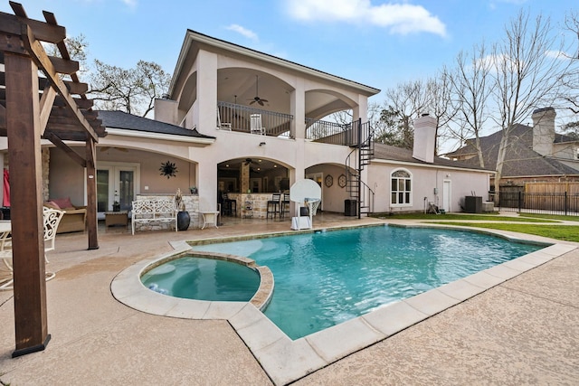back of house featuring a balcony, stucco siding, ceiling fan, french doors, and a patio