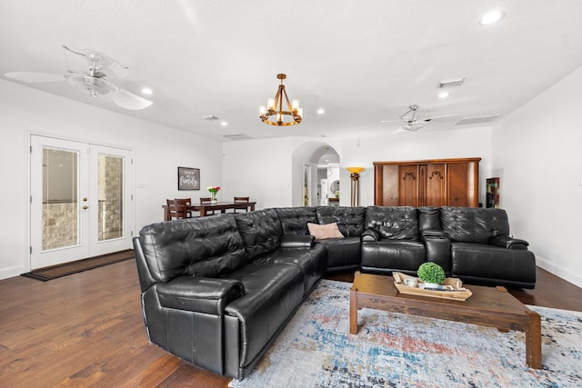 living room featuring wood finished floors, ceiling fan with notable chandelier, arched walkways, visible vents, and recessed lighting