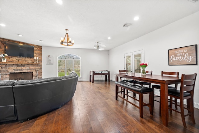 living area featuring a fireplace, dark wood finished floors, baseboards, visible vents, and recessed lighting