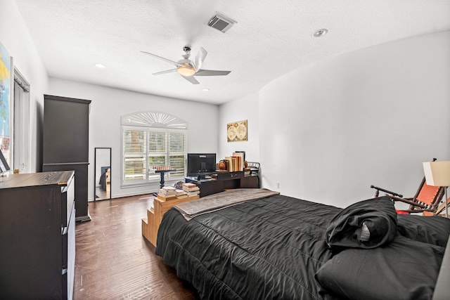 bedroom featuring dark wood-style floors, a textured ceiling, visible vents, and recessed lighting