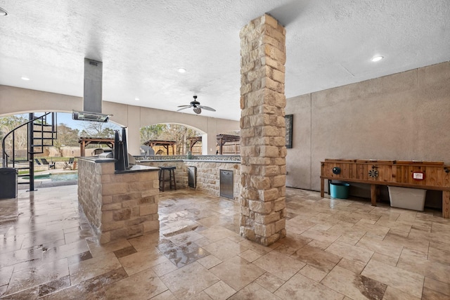 view of patio featuring ceiling fan, an outdoor pool, area for grilling, and outdoor wet bar