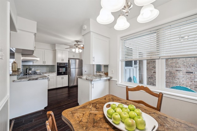 kitchen featuring tasteful backsplash, oven, dark wood-type flooring, freestanding refrigerator, and white cabinetry