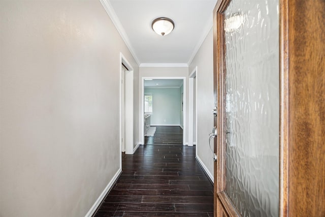 corridor featuring dark wood-style floors, baseboards, and ornamental molding