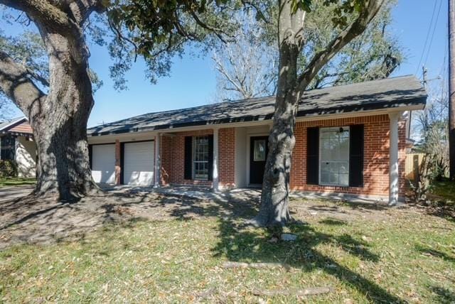 single story home with an attached garage and brick siding