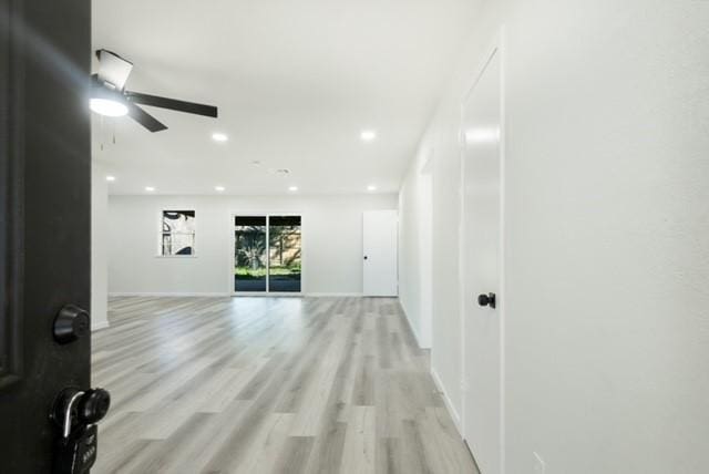 empty room with recessed lighting, baseboards, light wood-style floors, and ceiling fan