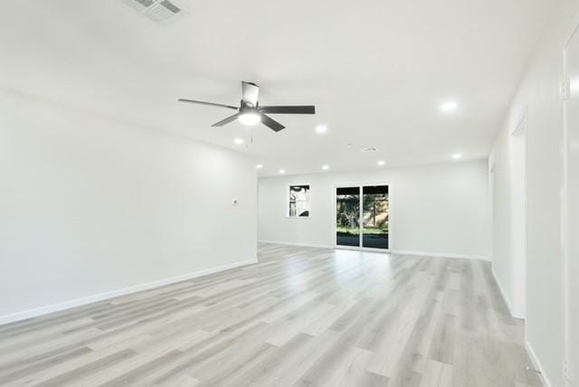 unfurnished room with visible vents, light wood-style flooring, recessed lighting, and baseboards