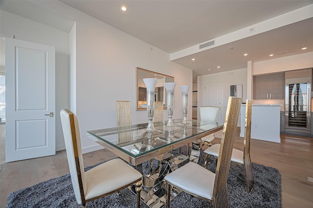 dining room with recessed lighting, light wood-type flooring, baseboards, and visible vents