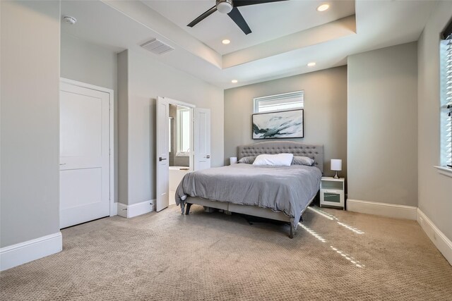 carpeted bedroom featuring baseboards, visible vents, a tray ceiling, recessed lighting, and ceiling fan