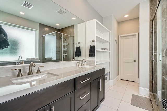 full bath featuring tile patterned flooring, a shower stall, visible vents, and a sink