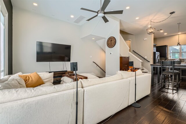 living area featuring dark wood finished floors, stairs, recessed lighting, and visible vents