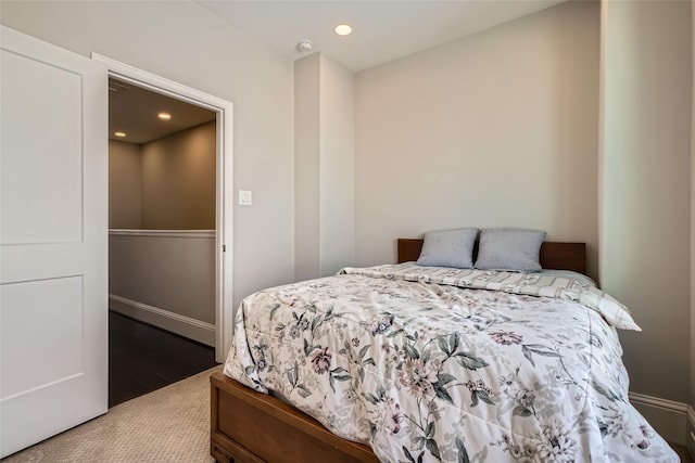 bedroom featuring wood finished floors, recessed lighting, and baseboards