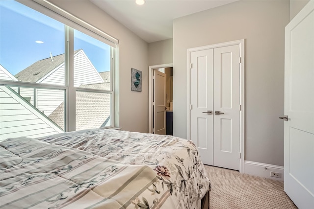 bedroom featuring a closet, carpet flooring, and baseboards