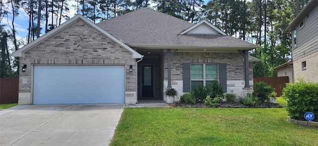 single story home with fence, a front yard, a shingled roof, a garage, and brick siding