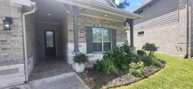 entrance to property featuring brick siding and stone siding