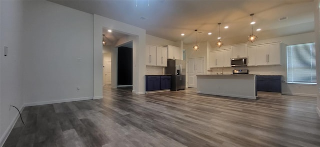 kitchen with baseboards, dark wood finished floors, open floor plan, appliances with stainless steel finishes, and white cabinetry