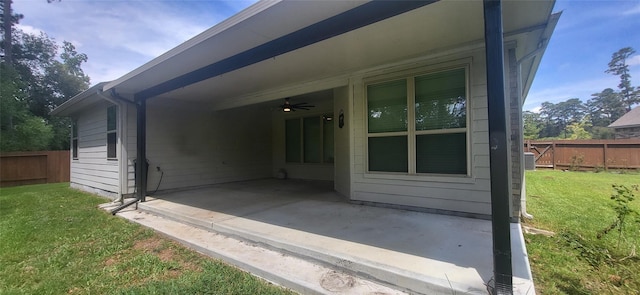 view of property exterior with a carport, a patio area, a lawn, and fence