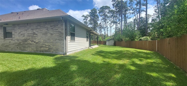 view of property exterior featuring a storage shed, a fenced backyard, brick siding, and an outdoor structure