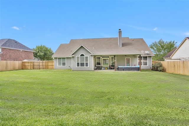 back of property featuring an outdoor living space, ceiling fan, a yard, a fenced backyard, and a patio area