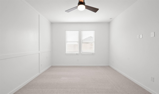 unfurnished room featuring light carpet, baseboards, and ceiling fan