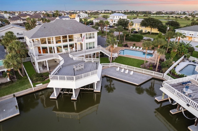 3515 Jolly Roger Cir, Galveston, TX 77554 - dock area with a balcony, a community pool, a deck with water view, and a residential view