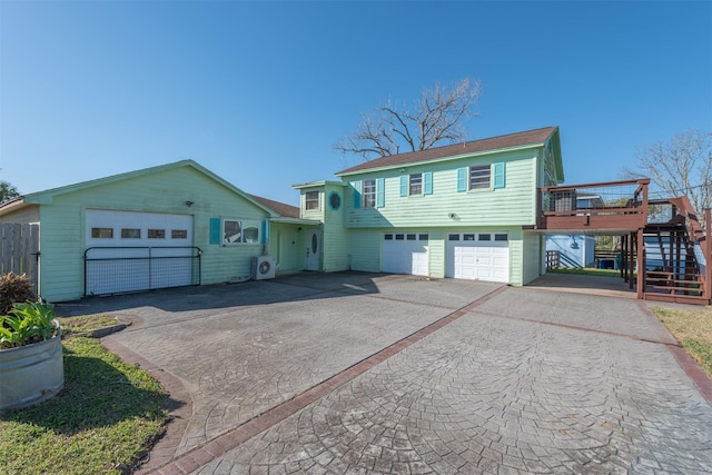 view of front facade with aphalt driveway, stairs, and a garage