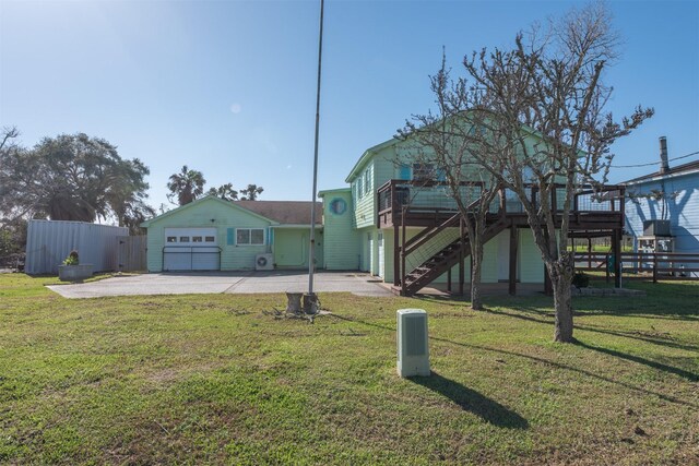 exterior space with driveway, stairs, a front lawn, and fence