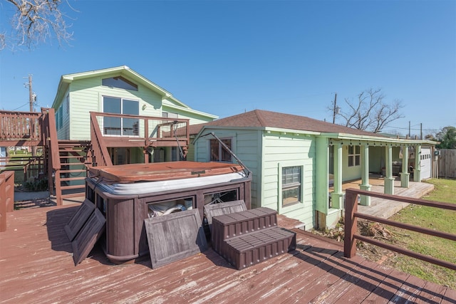 wooden deck with stairway and a hot tub