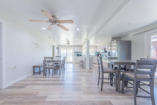 dining area with recessed lighting, light wood-style flooring, and baseboards