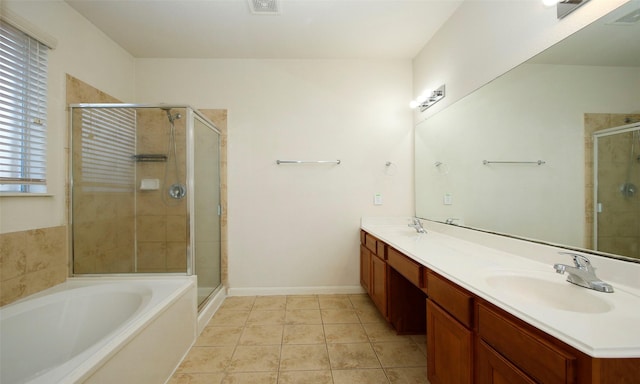 bathroom with tile patterned flooring, a shower stall, double vanity, and a sink