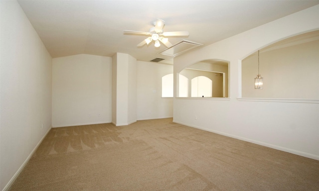 spare room with visible vents, baseboards, lofted ceiling, carpet flooring, and a ceiling fan