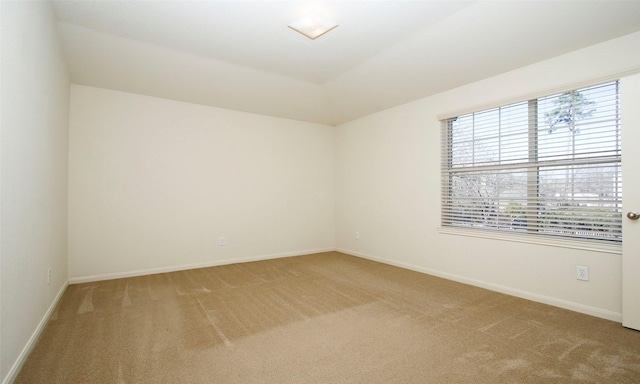 empty room with baseboards and light carpet