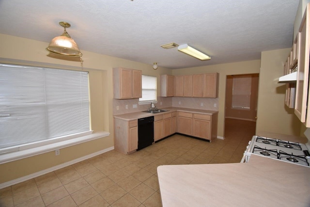 kitchen with light brown cabinetry, light countertops, black dishwasher, light tile patterned floors, and a sink