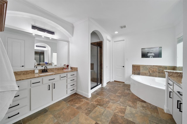 bathroom with a shower stall, vanity, and ornamental molding