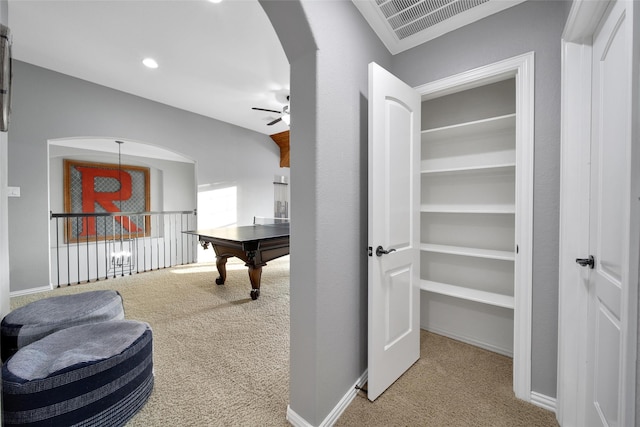 rec room with visible vents, arched walkways, carpet flooring, baseboards, and ceiling fan