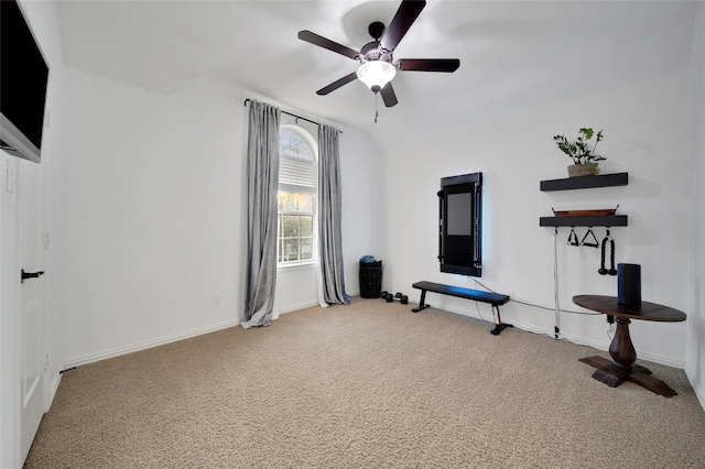 workout area featuring baseboards, ceiling fan, and carpet flooring