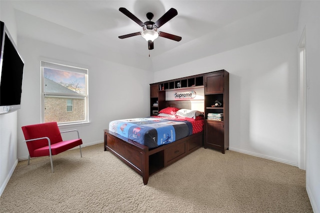 bedroom with a ceiling fan, light colored carpet, and baseboards