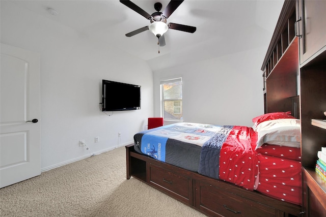 bedroom with baseboards, light colored carpet, lofted ceiling, and ceiling fan