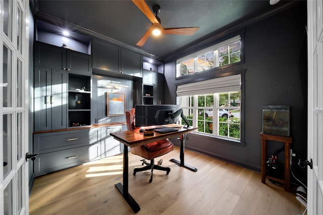 office area with a ceiling fan, light wood-style floors, and ornamental molding