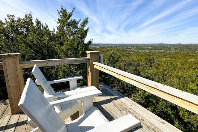 wooden terrace with a view of trees