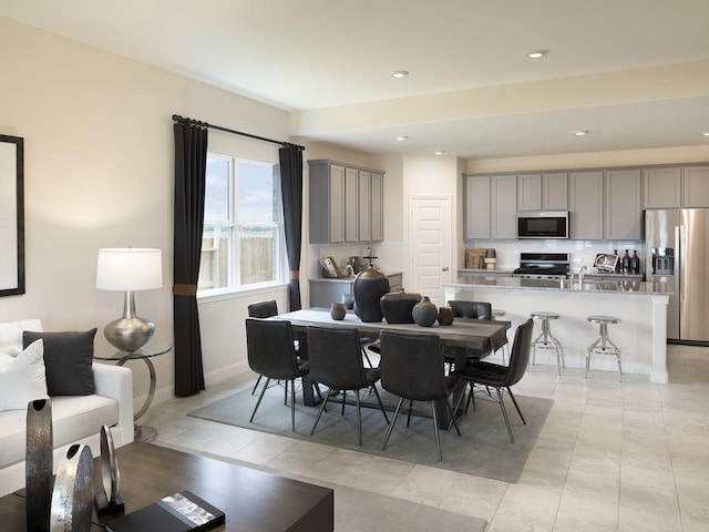 dining area with light tile patterned floors, recessed lighting, and baseboards