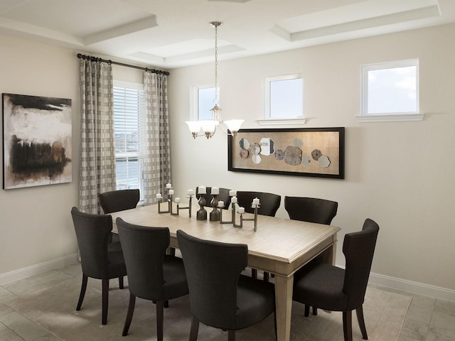 dining area with a wealth of natural light, baseboards, and a chandelier